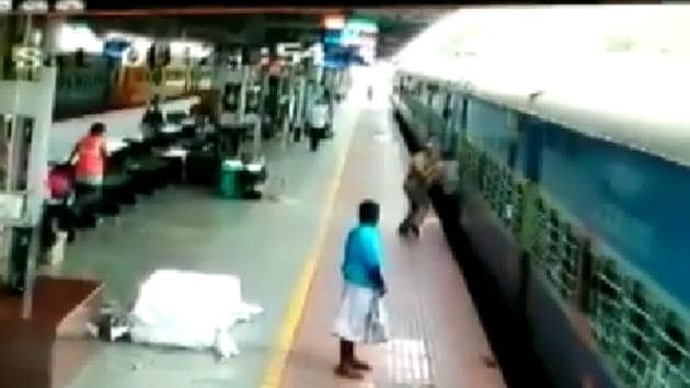 An RPF personnel - standing merely five feet away from the train - swings into action and pushes the man inside the coach.(Twitter/@ANI)