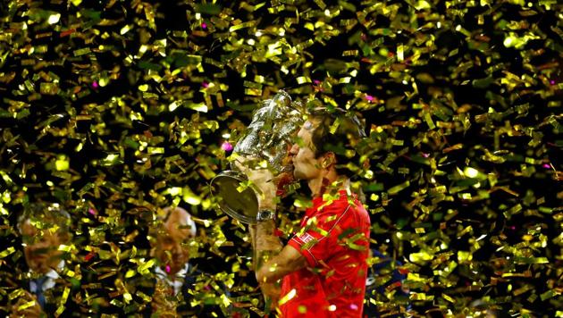 Switzerland's Roger Federer celebrates with the trophy after winning the final against Australia's Alex de Minaur(REUTERS)
