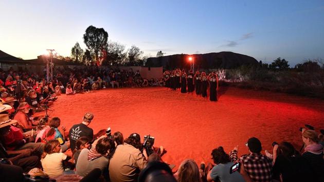Indigenous Anangu perform a traditional dance during a ceremony marking the permanent ban on climbing Uluru, also known as Ayers Rock, at Uluru-Kata Tjuta National Park in Australia’s Northern Territory. Indigenous Australians performed songs and traditional dance as the sun set over Uluru on Sunday, capping a weekend of celebrations to mark the historic ban on climbing the sacred site. (Saeed Khan / AFP)