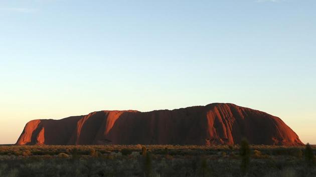 The ceremony was held two days after a final surge of tourists had flocked to scale the giant red monolith before its closure to climbers. The ban, first announced in 2017, had long been sought by the traditional owners of the land, the Anangu, whose connection to the site dates back tens of thousands of years. (Rob Griffith / AP)