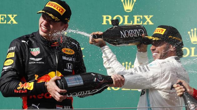 Lewis Hamilton, right, with second placed Red Bull driver Max Verstappen.(AP)