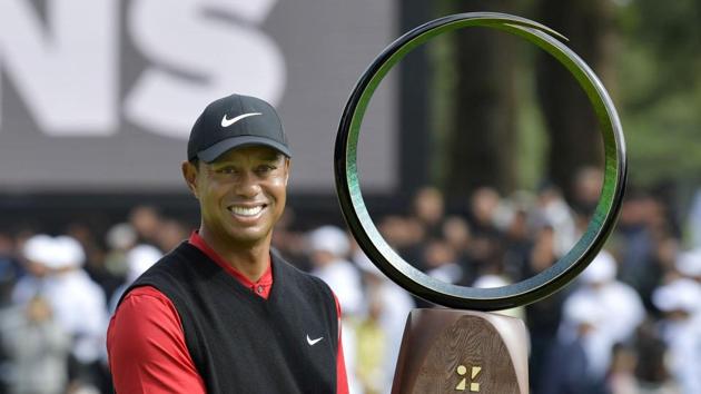 Tiger Woods holds a winning trophy as he celebrates winning the Zozo Championship.(Kyodo/via REUTERS)