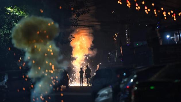 Crackers being burst on the occasion of Diwali in Delhi. The national capital’s air quality dropped to the season’s worst on Monday morning, but the situation was still better than the last three years, according to government agencies. SAFAR had predicted that AQI will dip and enter “severe” category. In a statement, it said that wind speed direction and speed may help disperse the pollutants by Tuesday. (Sanchit Khanna / HT Photo)