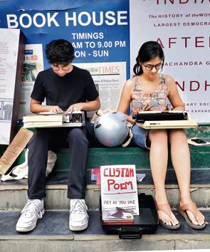 Rahul Kondi and fellow busker, Nisshtha Khattar type out customised poems for strangers outside Blossom Book House in Bengaluru(Picture courtesy/Rahul Kondi)