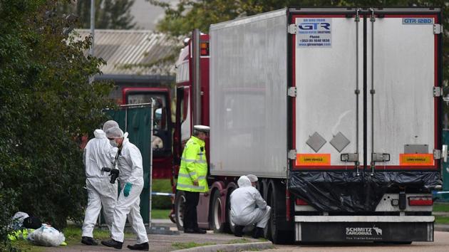 British Police forensics officers work on the lorry, found to be containing 39 dead bodies, east of London, on October 23, 2019. “If he took the grass route, I’m 100 percent sure he died,” Gia said. “The vehicle in this incident ... that’s the grass route.” That option, which involves travelling from the Southeast Asian country overland to Europe, means arduous months of secretive movement by car and even walking. (Ben Stansall / AFP)