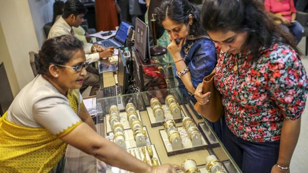 Customers browse gold bangles inside a store. “Gifting has almost vanished in gold,” Solanki said. “Earlier people used to buy jewellery for gifting in the range of 5,000 rupees to 10,000 rupees. You can’t really buy anything in gold in that range nowadays as just one gram of gold will put you back by 4,500 rupees.” (Dhiraj Singh / Bloomberg)