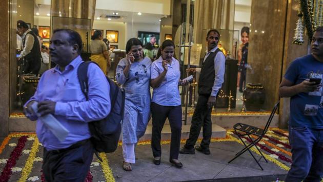 Customers exit a Titan Co. Tanishq jewellery store. Demand for silver was also sluggish. Rishabh Angara, 25, said his wait to buy silver coins in Zaveri Bazaar was the shortest he’d had in years. “Usually, I have to wait 45 minutes at least before I can make my customary Dhanteras purchase of 50 grams. But this year, I think I should be done sooner.” (Dhiraj Singh / Bloomberg)