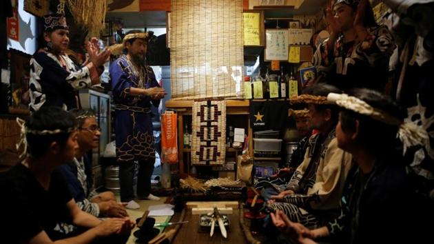 Indigenous Ainu Teruyo Usa (R) attends a traditional ritual ceremony to mark the eighth anniversary of the opening of her Ainu restaurant in Tokyo. “Society was not accepting of the Ainu, and it still isn’t,” said Mai Ishihara, an anthropologist at Hokkaido University. “There are still many people who keep their Ainu identity secret from their children.” (Kim Kyung-Hoon / REUTERS)