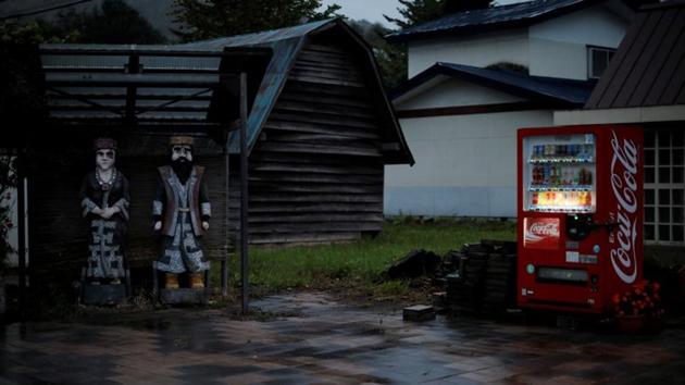 Wooden statues of an Ainu couple stand in front of an Ainu craft shop in the Nibutani district where several Ainu craft shops and a museum are located, in Biratori, Hokkaido Prefecture. A 2017 survey counted just over 13,000 Ainu in Hokkaido. The actual number is estimated to be much higher, because many Ainu fear identifying as other than Japanese and have moved to different parts of the country. (Kim Kyung-Hoon / REUTERS)