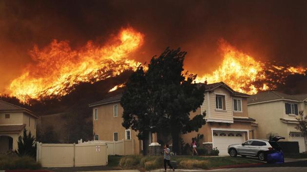 A wildfire approaches a residential subdivision in Santa Clarita, California.(AP)