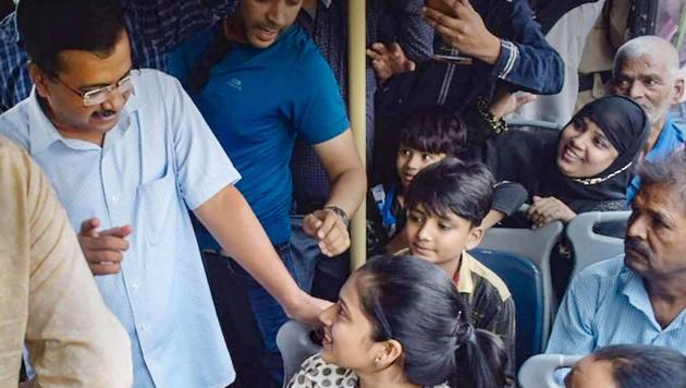 Delhi Chief Minister Arvind Kejriwal interacts with women passengers to get feedback about his government's free-ride scheme, in New Delhi on Wednesday(PTI Photo)