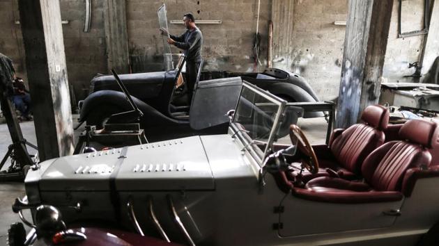 Munir Shindy at work on his Armstrong Siddeley. Even when the car is eventually purring, which Shindi estimates will take another couple of months, it will not be able to go far. Gaza is only 365 square kilometres, 40 kilometres north to south. (Mahmud Hams / AFP)
