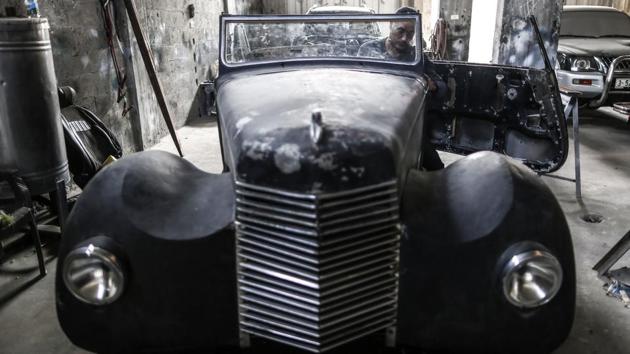 Munir al-Shindi, a 40-year-old Palestinian who restores old cars as a hobby, works on a 1946 Armstrong Siddeley at his workshop in Gaza City. The 40-year-old is known in the Palestinian enclave for his obsession with old-fashioned cars, fixing them up in his workshop northeast of Gaza City. (Mahmud Hams / AFP)