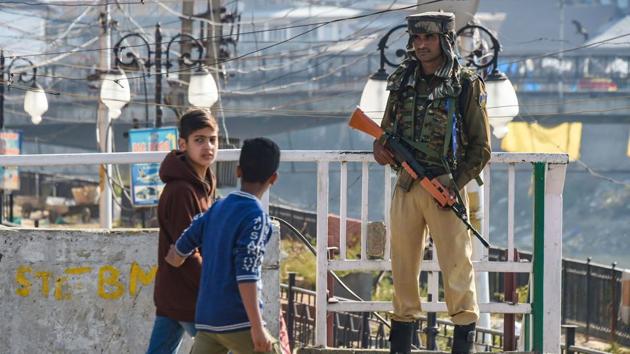 A security person stands guard during shutdown in Srinagar during a shutdown in Kashmir after the centre abrogated Article 370 and divided Jammu and Kashmir into two union territories.(PTI Photo) A security person stands guard during shutdown in Srinagar during a shutdown in Kashmir after the centre abrogated Article 370 and divided Jammu and Kashmir into two union territories.(PTI Photo)
