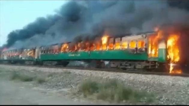 A fire burns a train carriage after a gas canister passengers were using to cook breakfast exploded, near the town of Rahim Yar Khan in the south of Punjab province, Pakistan. (Reuters photo) A fire burns a train carriage after a gas canister passengers were using to cook breakfast exploded, near the town of Rahim Yar Khan in the south of Punjab province, Pakistan. (Reuters photo)