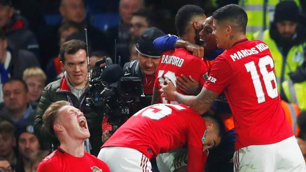 Manchester United's Marcus Rashford celebrates scoring their second goal with Scott McTominay and teammates.(REUTERS)