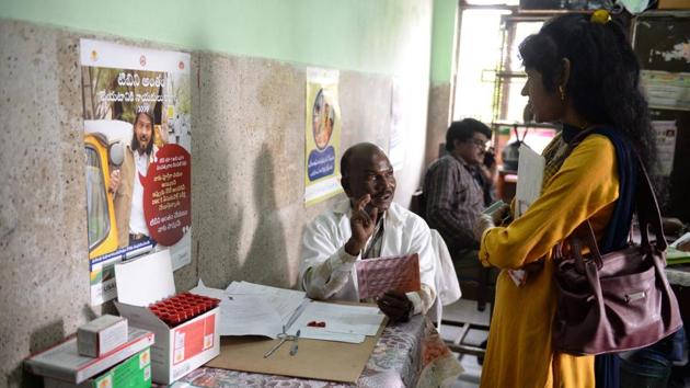 A medical supervisor (C) holds a packet of medicine to treat TB as he talks with a patient in the government-run Osmania General Hospital. South African Tuberculosis Vaccine Initiative director Mark Hatherill said a vaccine would be “the only way in the short-term to interrupt TB transmission and get control of the epidemic.” (Noah Seelam / AFP)