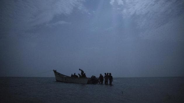 Ethiopian migrants board a boat on the uninhabited coast outside the town of Obock, Djibouti, the shore closest to Yemen. Tens of thousands of East African migrants depart for Yemen each year hoping to pass through to Saudi Arabia, where good jobs await. But many who land in the Yemeni town of Ras Al-Ara encounter extortion, rape and torture. (Nariman El-Mofty / AP)