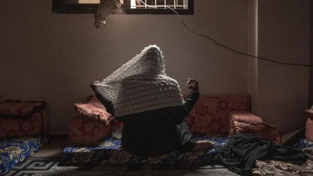 Zahra adjusts her veil for a photograph, in Basateen. The ones stranded in Yemen’s nightmare are also due to some measure by Europe shutting its doors, outsourcing migrants to other countries. The EU began paying Libyan coast guards to stop migrants there, blocking the other main route out of East Africa, through Libya and across the Mediterranean to Europe. (Nariman El-Mofty / AP)