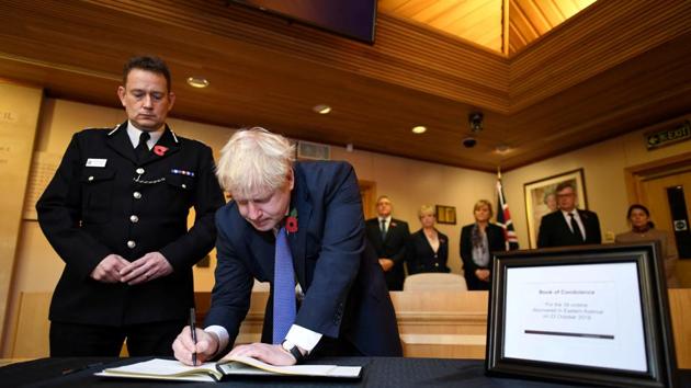 Britain’s Prime Minister Boris Johnson signs a book of condolence for the 39 dead found in lorry, during a visit to Thurrock Council Offices in Grays, England. (Stefan Rousseau / Pool via REUTERS) Britain’s Prime Minister Boris Johnson signs a book of condolence for the 39 dead found in lorry, during a visit to Thurrock Council Offices in Grays, England. (Stefan Rousseau / Pool via REUTERS)