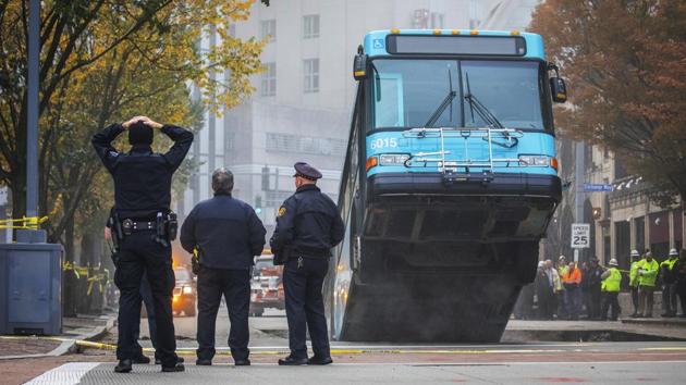 A Port Authority bus sticks out of a large sinkhole on 10th Street near Penn Avenue in Pittsburgh, Pennsylvania. (Andrew Rush / Pittsburgh Post-Gazette via AP) A Port Authority bus sticks out of a large sinkhole on 10th Street near Penn Avenue in Pittsburgh, Pennsylvania. (Andrew Rush / Pittsburgh Post-Gazette via AP)