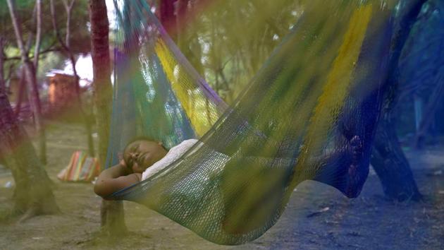 A Mexican asylum-seeking woman sleeps in a hammock in an encampment where she lives as she waits for her turn to seek asylum in the US in Matamoros, Mexico. (Veronica G. Cardenas / REUTERS) A Mexican asylum-seeking woman sleeps in a hammock in an encampment where she lives as she waits for her turn to seek asylum in the US in Matamoros, Mexico. (Veronica G. Cardenas / REUTERS)