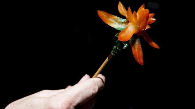 Louis To displays a flower-shaped piece of candy he made. To’s technique is a centuries-old folk art form in mainland China but there are few people in Hong Kong with the knowledge or skillset. (Isaac Lawrence / AFP) Louis To displays a flower-shaped piece of candy he made. To’s technique is a centuries-old folk art form in mainland China but there are few people in Hong Kong with the knowledge or skillset. (Isaac Lawrence / AFP)