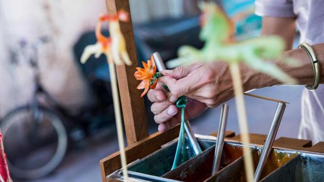 “In Cheung Chau, I saw many things that reminded me of my childhood -- flying kites, lion dances... things that you don’t see in the city, only here,” To said. “And I remembered that I wanted to craft candies.” With no recipes to guide him, To started experimenting himself, melting all kinds of sugars. (Isaac Lawrence / AFP) “In Cheung Chau, I saw many things that reminded me of my childhood -- flying kites, lion dances... things that you don’t see in the city, only here,” To said. “And I remembered that I wanted to craft candies.” With no recipes to guide him, To started experimenting himself, melting all kinds of sugars. (Isaac Lawrence / AFP)