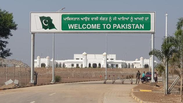 A view of the illuminated Gurudwara Darbar Sahib seen through the Pakistani gate, at Kartarpur, in Punjab, Pakistan.(HT Photo)