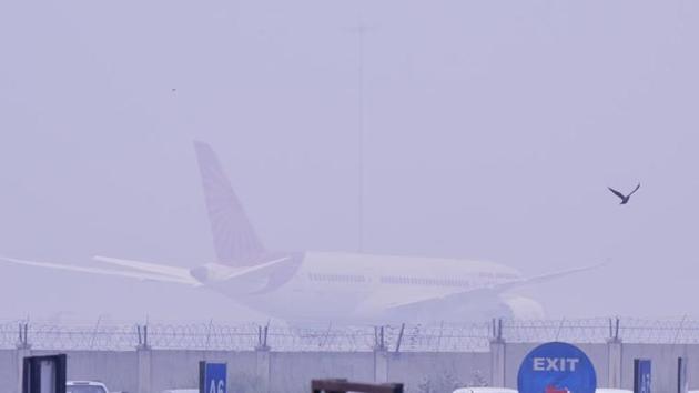 An Air-India aircraft is seen amid heavy smoke, at Terminal 3, IGI airport (Vipin Kumar/ Hindustan Times) An Air-India aircraft is seen amid heavy smoke, at Terminal 3, IGI airport (Vipin Kumar/ Hindustan Times)