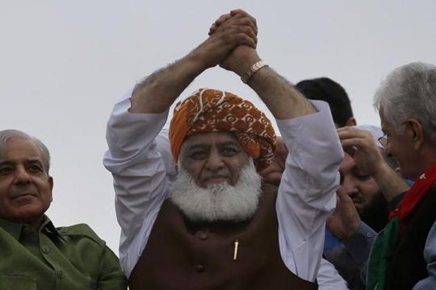 Prime Minister Imran Khan is not in any danger of being overthrown, but the Jamiat Ulema-e-Islam-Fazl’s rally makes his survival now almost completely dependent on the whim of the Pakistani military (AP) Prime Minister Imran Khan is not in any danger of being overthrown, but the Jamiat Ulema-e-Islam-Fazl’s rally makes his survival now almost completely dependent on the whim of the Pakistani military (AP)