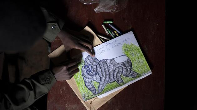 Jean Claude Masengesho draws a silverback gorilla in Kinigi, Rwanda. He would like to someday become a tour guide, which would earn him about $320 monthly. The obstacle is that most tour guides have attended college, and the 21-year old isn’t sure how his family can afford tuition. “It’s my dream, but it’s very hard,” he says. “In this village, every young person’s dream is to work in the park.” (Felipe Dana / AP)