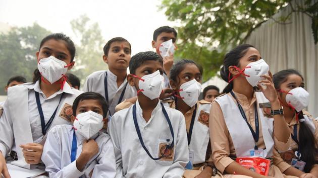 Children are seen wearing anti-pollution masks distributed by Delhi Chief Minister Arvind Kejriwal during an event, at Rajkiya Pratibha Vikas Vidyalaya, in New Delhi. (Sanchit Khanna / HT Photo)