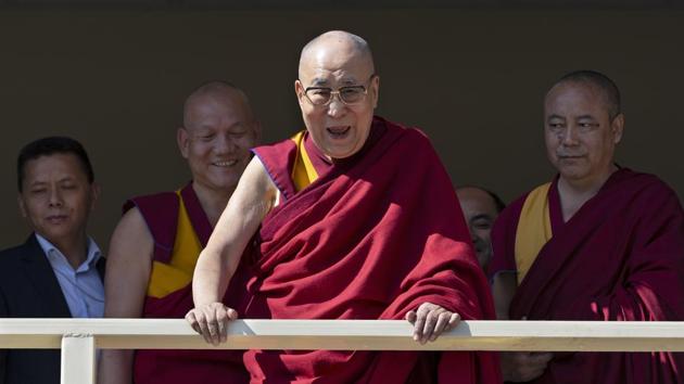 Tibetan spiritual leader the Dalai Lama laughs as he addresses a group of artists from a balcony at the Tibetan Institute of Performing Arts in Dharmsala, Himachal Pradesh. The institute, which was established to preserve and promote Tibetan theatrical arts, celebrated its 60th founding anniversary on October 29. (Ashwini Bhatia / AP)