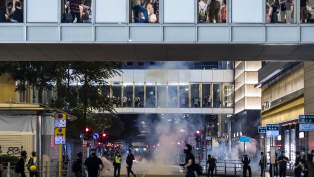 Demonstrators are shrouded in a cloud of tear gas during a protest in the Central district of Hong Kong(Bloomberg photo) Demonstrators are shrouded in a cloud of tear gas during a protest in the Central district of Hong Kong(Bloomberg photo)