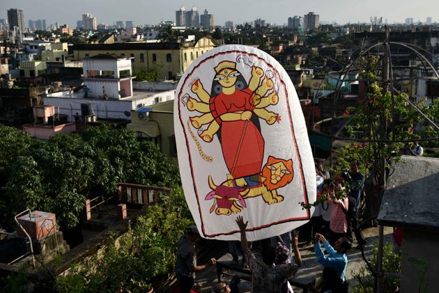 A paper-made hot air balloon (popularly known as ‘Fanush’) made by PK Mullick, painted with Durga from Kusum Smriti , on the occasion of Diwali/ Kali Puja, at Beadon street, in Kolkata, West Bengal. Though the art of fanush-making is a dying, in the recent years, fanush has become an integral part of Kolkata’s Kali Puja celebrations. The air inside the fanush is heated by a cloth rag ball (locally called Luti) soaked in spirit. The Luti is then attached to the base of the fanush. (Samir Jana / HT Photo)