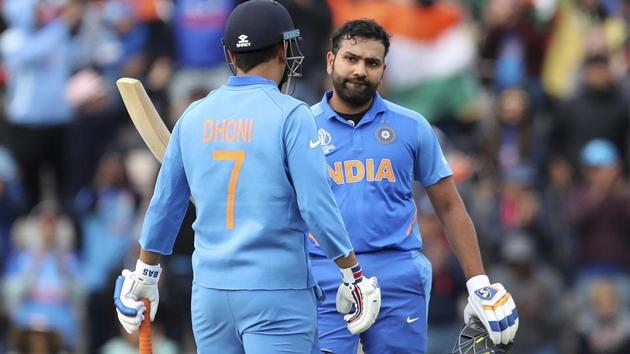 Rohit Sharma, right, celebrates scoring a century with teammate MS Dhoni during the Cricket World Cup.(AP)