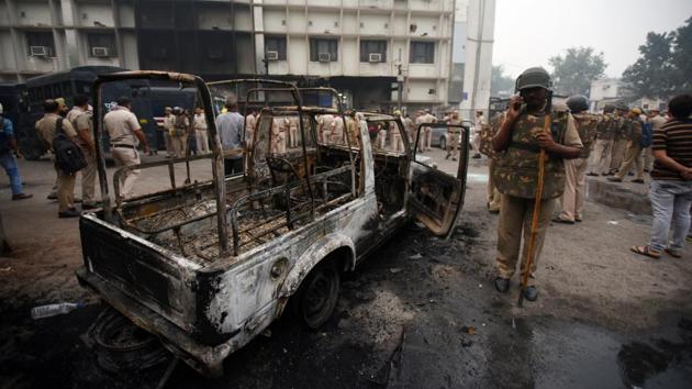 A burnt police vehicle inside the Tis Hazari Court Complex after a dispute over parking in the afternoon escalated into a full-blown clash between the police and the lawyers, in New Delhi. (Amal KS / HT Photo)