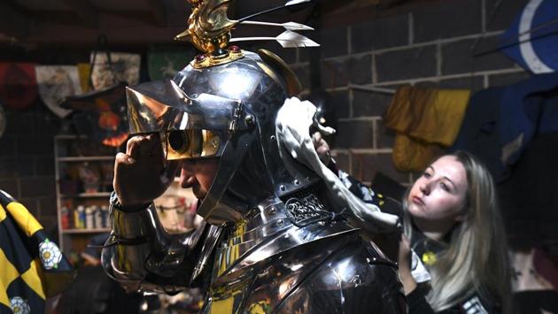 Tawny Gallop (R) polishes the equipment of England’s jousting competitor Stacy van Dolah-Evans. Dressed head-to-toe in medieval-style armour an mounted on steeds sporting skirts in team colours, the competitors charged one another on opposite sides of a barrier, scoring points if they could break their wooden lances against the opponent’s torso -- one point for a broken lance, three points if it shatters. (William West / AFP)