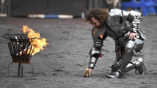 Australia’s captain Phil Leitch places the Ashes trophy in front of a burning lance after Australia defeated England in the inaugural Ashes jousting tournament. Australia took top honours in the inaugural version of the tournament with 89 points to 75 for England. “The next Ashes will be taking place in England in two years time and they’ll have the chance to win the trophy and take it over there,” said the Australian captain. (William West / AFP)