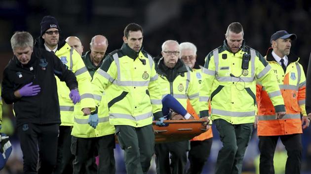 Everton's Andre Gomes is carried off the field by medical staff.(AP) Everton's Andre Gomes is carried off the field by medical staff.(AP)