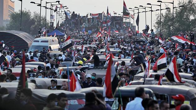 Anti-government protesters gather on the Joumhouriya closed bridge leading to the Green Zone government areas during ongoing protests in Baghdad. Anti-government protesters crossed a major bridge in central Baghdad on Monday, approaching the headquarters of state-run TV and coming to within 500 meters (yards) of the prime minister’s office, as security forces fired live ammunition and tear gas, killing at least five protesters and wounding dozens. (AP Photo)