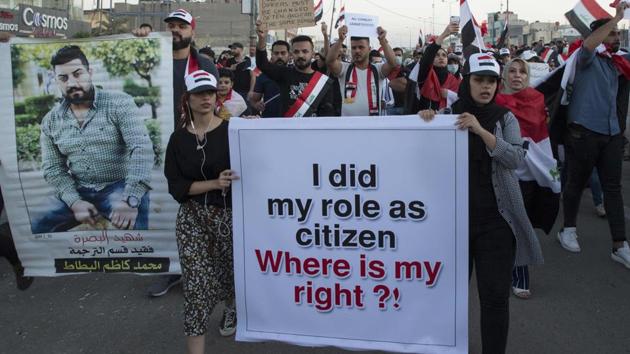 Iraqi protesters march during ongoing anti-government demonstrations in the southern city of Basra. The protesters have increasingly directed their anger at Iran, which has close ties to the government, Shiite political factions and paramilitary groups. (Hussein FALEH / AFP)