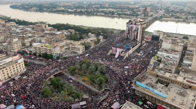 An aerial view shows Iraqi protesters gathering at Baghdad's Tahrir square. Over the last two days, protesters have blocked roads around the main protest site in Baghdad’s Tahrir Square to raise pressure on the government. They appeared to be borrowing a tactic from Lebanon, where similar anti-government demonstrations have been underway since Oct. 17, and where protesters have repeatedly blocked major roads in order to ramp up pressure on authorities. (AFP)