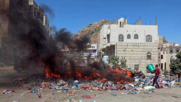 A Yemeni man disposes of rubbish at a garbage dump on a main street. Cholera, which can kill within hours if left untreated, reappeared in Yemen in April after an initial outbreak in October 2016. The World Health Organization said that 304 people died of the disease between April 2017 and August 2019 in Taez, with cases fluctuating from week to week. (AHMAD AL-BASHA / AFP)