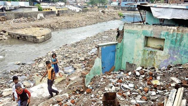 Debris on the banks of the Ambil odha (stream) remains strewn with what once was houses lying destroyed.(HT Photo) Debris on the banks of the Ambil odha (stream) remains strewn with what once was houses lying destroyed.(HT Photo)