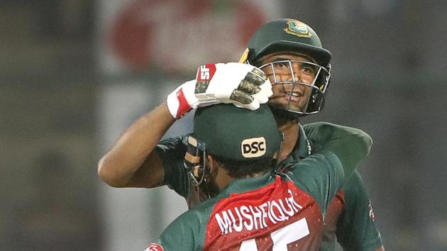 Bangladesh cricket team captain Mahmudullah, behind, celebrates with his team member Mushfiqur Rahim after wining first T20I.(AP)