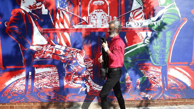 A man walks in front of new murals of the former US embassy in Tehran, Iran November 2, 2019. (VIA REUTERS)