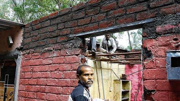A Tangewala colony resident at work on his house which was destroyed in the floods. (HT Photo) A Tangewala colony resident at work on his house which was destroyed in the floods. (HT Photo)