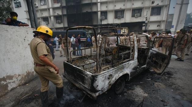 A fire service personnel near a burnt police vehicle inside the Tis Hazari Court Complex after a clash between the police and the lawyers, in New Delhi, on Saturday, November 2, 2019. (Amal KS/HT PHOTO) A fire service personnel near a burnt police vehicle inside the Tis Hazari Court Complex after a clash between the police and the lawyers, in New Delhi, on Saturday, November 2, 2019. (Amal KS/HT PHOTO)